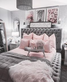 a bedroom with pink and gray decor in the corner, including a tufted bed