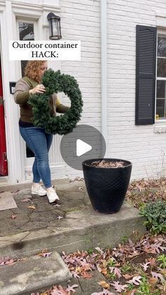 a woman holding a wreath in front of a house with the words outdoor container hack