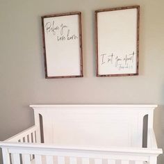 two framed pictures hang on the wall above a crib