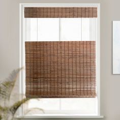 a window with a bamboo blind in front of it