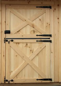 a close up of a wooden door with metal bars on the front and side panels