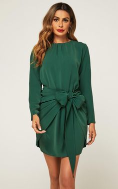 Elevate your wardrobe with the Long Sleeve Knot Tie Front Mini Dress in Green, a perfect blend of chic style and playful charm. This dress features a vibrant green hue that adds a refreshing touch to your look. The long sleeves provide a touch of sophistication, while the mini length adds a flirty and contemporary flair. The knot tie front detail creates a flattering cinched waist, accentuating your silhouette with a hint of allure. Whether you're attending a daytime event or a night out on the town, this dress is a versatile choice that effortlessly combines comfort and trendsetting fashion. Step out with confidence in this eye-catching ensemble that's sure to turn heads and leave a lasting impression. Red Long Sleeve Dress, Winter Knit Sweater, Long Sleeve Wrap Dress, Dinner Dress, Long Sleeve Short Dress, Lantern Sleeve, Lantern Sleeves, Short Dress, Women Long Sleeve