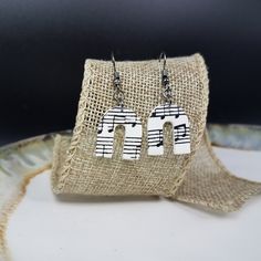 the earrings are made out of wood and have musical notes on them, as well as letters