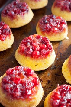 small pastries with jam on them sitting on a baking sheet, ready to be baked