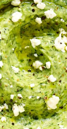 a bowl filled with guacamole and white cauliflower florets