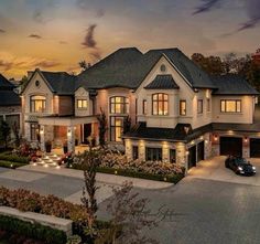 an aerial view of a luxury home at dusk