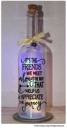 a bottle with some writing on it and a bow tied around the top that says, its the friends we meet along the way