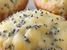 there are some muffins with cheese and black seed toppings on them,