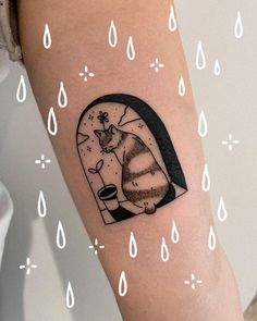 a cat in a glass dome tattoo on the right arm and leg with water drops around it