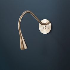 a bathroom faucet that is on the wall with a hose attached to it