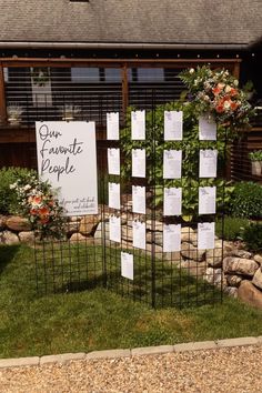 a sign that says our favorite people on it in front of some flowers and rocks