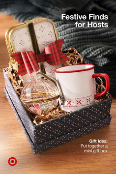 a gift box filled with coffee, tea and other items on top of a wooden table