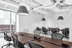 an empty conference room with chairs and desks