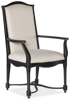 the arm chair is upholstered with studding on it's back legs