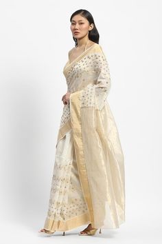 Ivory chanderi saree embroidered with golden threads and pearls. Comes with running blouse piece. - Aza Fashions White Chanderi Pre-draped Saree For Celebration, White Chanderi Pre-draped Saree With Zari Work, Off White Designer Pre-draped Saree For Festive Occasions, Festive White Pre-draped Saree With Cutdana, Festive Cream Pre-draped Saree With Cutdana, Gold Chanderi Embroidered Fabric For Reception, Gold Embroidered Chanderi Fabric For Reception, Gold Cotton Silk Pre-draped Saree For Reception, Festive Off White Raw Silk Traditional Wear