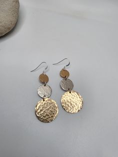 These long hammered circle earrings are made from high quality gold fill and sterling silver disks. They are hand hammered to give a beautiful texture and to catch the light for a radiant shine. They hang from small gold fill french ear wires which are completely hypoallergenic.  They are simple and elegant and look great with a dress, evening gown or jeans and a t-shirt. They will be your new favorite earrings!  Also available in sterling silver with gold center, all gold and all silver. Please Hammered Recycled Gold Earrings, Hammered Recycled Gold Drop Earrings, Hammered Metal Round Earrings, Gold Plated Hammered Drop Earrings, Hammered Disc Earrings, Hammered Brass Round Disc Earrings, Silver Earrings Long, Dangle Earrings Gold, Disc Earrings