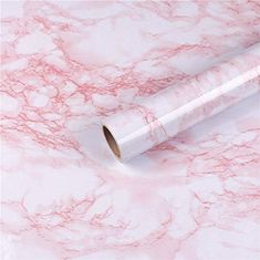 two rolls of pink marble paper sitting on top of each other