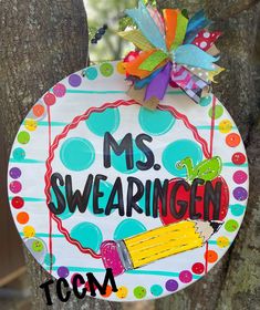 a sign that says ms swaeeringen hanging from the side of a tree