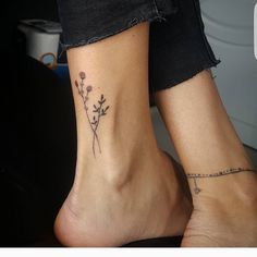 two people with tattoos on their feet and one has a flower tattoo on the ankle