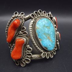 "VINTAGE NAVAJO BRACELET DESCRIPTION: This exquisite cuff features a huge oval specimen of Waterweb Turquoise, flanked by four plump pieces of old red Mediterranean branch coral. The gemstones are secure in sawtooth bezel, on a foundation of heavy gauge, hand stamped vintage sterling silver This bracelet will be a cherished addition to your collection of fine vintage Native American jewelry. MEASUREMENTS: Interior of the cuff measures 6\" with an additional 1 1/4\" non-adjustable gap. Total circ Vintage Native American Jewelry, Navajo Bracelet, Turquoise Bracelet Cuff, Turquoise Cuff, Vintage Navajo, Denver Co, American Jewelry, Native American Jewelry, Vintage Sterling Silver