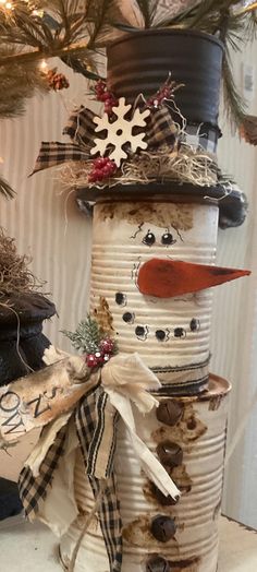 a snowman made out of old tin cans