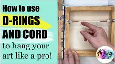 a hand pointing at the inside of a box with text overlaying how to use d - rings and cord to hang your art like a pro