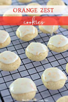 orange zest cookies with white frosting on a cooling rack in front of them