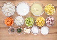 several bowls with different types of food in them on a wooden counter top, including diced onions, carrots, celery, and other ingredients