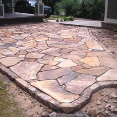 a large stone walkway in the middle of a yard