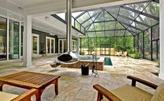 the inside of a house with lots of windows and furniture in front of an outdoor pool