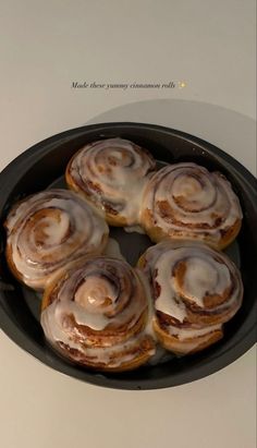 some cinnamon rolls are in a pan on the table