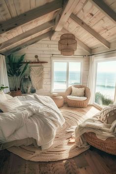 a bedroom with a bed, chair and window overlooking the ocean is pictured in this image