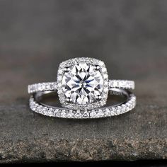 a diamond engagement ring on top of a rock