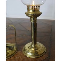 a brass candle holder with a glass ball on it