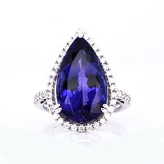 a large tanzante and diamond ring with an oval cut blue stone in the center