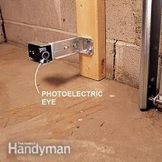 an electrical device is attached to the side of a brick wall with metal bars and screws