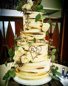 an image of a wedding cake with flowers on it