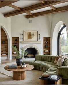 a living room filled with furniture and a fire place in the middle of an open floor plan