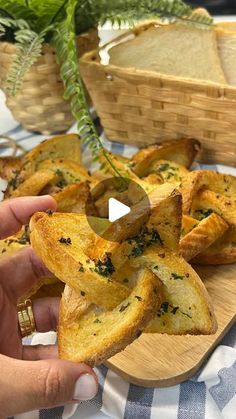 a person is holding some bread on a cutting board