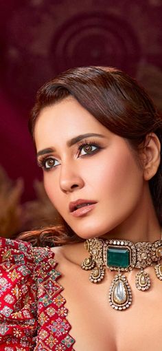 an image of a beautiful woman with jewelry on her neck and chest posing for the camera