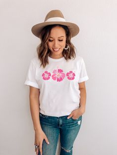 Hawaiian Shirt featuring pink hibiscus flowers -- size up for an oversized fit (see size chart in listing photos). Looking for additional outdoor/vacation/warm weather apparel? Check these out: https://www.etsy.com/shop/TheGraphicPeach?ref=seller-platform-mcnav§ion_id=31675954 Our shop uses direct-to-garment printing to make our products. The design ink is sprayed on, then allowed to soak into the fibers of the garment. This process yields fine quality prints and a smooth finish on the garment. White Hibiscus Print T-shirt For Spring, Pink Cotton Top With Palm Tree Print, White Cotton Top With Hibiscus Print, Pink Floral Print T-shirt For Summer, Pink Hawaiian Shirt For Summer, White Tropical Print T-shirt For Vacation, White Cotton Hibiscus Print Shirt, White Cotton Shirt With Hibiscus Print, Pink Relaxed Fit Summer Shirt