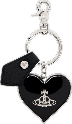 a heart shaped key chain with a black and white logo on the front, attached to a