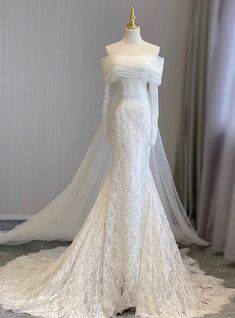 a white wedding dress on display in a room