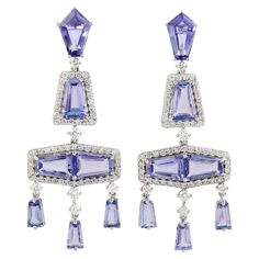 These beautiful drop earring are handcrafted in 14-karat gold. It is set with 7.72 carats tanzanite and 1.05 carats of diamonds. FOLLOW MEGHNA JEWELS storefront to view the latest collection & exclusive pieces. Meghna Jewels is proudly rated as a Top Seller on 1stDibs with 5 star customer reviews. All items manufactured by us are handmade and can be customized or redesigned. Composition Size 45X17 MM Total Weight-10.28 Diamond Wt(Cts)-1.05 Tanzanite Wt(Cts)-7.72 Elegant Tanzanite Formal Earrings, Elegant Tanzanite Earrings For Formal Occasions, Luxury Tanzanite Earrings, Luxury Tanzanite White Gold Earrings, Luxury White Gold Tanzanite Earrings, Formal Tanzanite Earrings In Fine Jewelry Style, Elegant Tanzanite Dangle Earrings, Luxury Tanzanite Gemstone Earrings, Luxury Tanzanite Drop Earrings