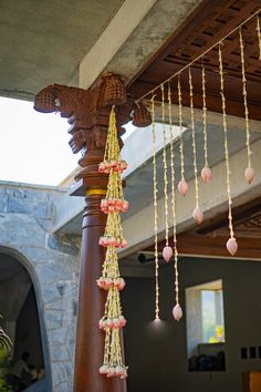 a wooden pole with beads hanging from it's sides and on top of it