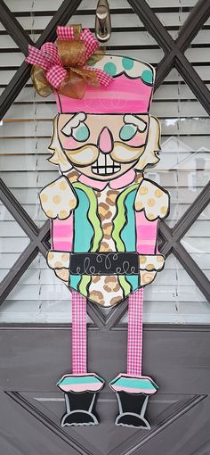 a paper cut out of a cartoon character is hanging on the front door to display it's art work