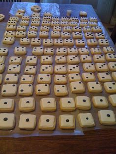 a table topped with lots of cookies covered in white frosting