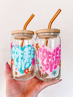 two glass jars with straws in them that say coffee love