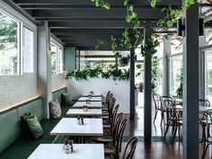 a dining room with green walls and white cabinets in the background, an open floor plan is shown