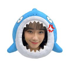 a person with a stuffed shark hat on